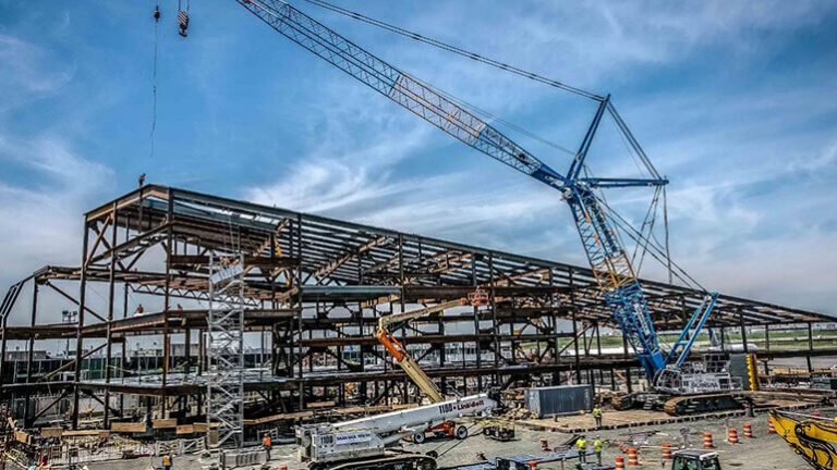 View of LaGuardia's Terminal B steel framework with large crane in the foreground